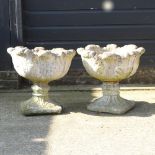 A pair of reconstituted stone planters,