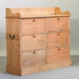 An antique pine cabinet, containing six hinged drawers,