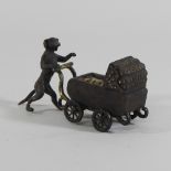 A Bergman style bronze figure group, in the form of a dog pushing a pram,