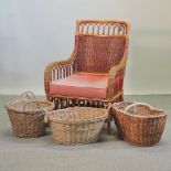 A wicker arm chair with a loose cushion, together with three wicker baskets,
