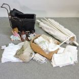 A collection of vintage linen, together with a dolls pram,