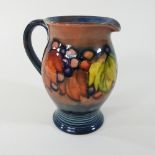 An early 20th century Moorcroft leaf and berry pattern jug,