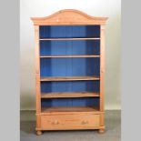 A large pine open bookcase, with drawer below,