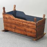 A 19th century pine cradle,