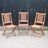 A set of three teak garden chairs,