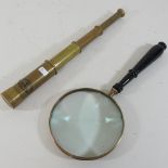 A reproduction German telescope, 37cm, together with a plated table magnifying glass,