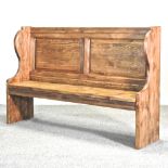 A large stained pine pew,