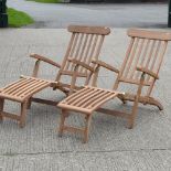 A pair of teak folding steamer chairs