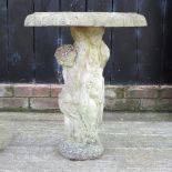 A reconstituted stone cherub bird bath,