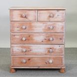 A stripped pine chest of drawers,