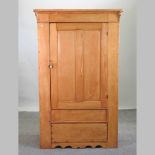 An antique pine single wardrobe,