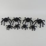 A collection of eight metal spiders