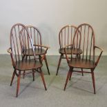 A set of four Ercol dark elm dining chairs,