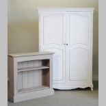 A white painted double wardrobe, 130cm, together with a grey painted dwarf bookcase,