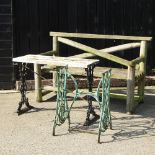 A rustic garden bench, 164cm, together with a garden table with a wrought iron base,
