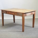 An antique pine dining table, on square tapered legs,