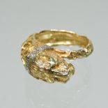 An 18 carat gold and diamond ring, of textured design,