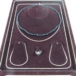 A ladies jewellery set, comprising a bead necklace, matching earrings and silver ring,