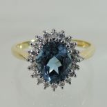 An 18 carat gold blue topaz and diamond cluster ring,