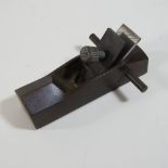 A small bronze model of a carpenter's plane,