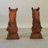 A rusted horse head finial, together with another,