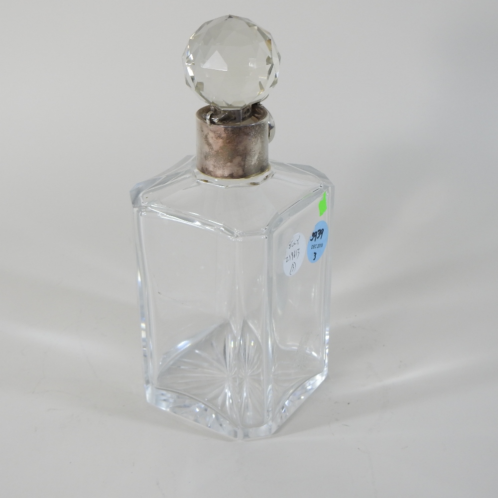 An early 20th century silver mounted glass decanter and stopper, with a lockable silver collar,