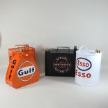 A collection of four reproduction metal oil advertising cans,