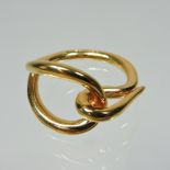 A Hermes 18 carat gold designer scarf ring, of openwork design, stamped marks,