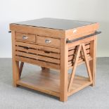 An oak freestanding kitchen island, with a granite top,