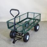 A green metal garden trolley,