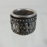 A modern Chinese white metal archer's ring, with relief decoration,