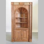 A 19th century barrel back standing corner cabinet,