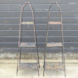 A pair of black painted iron plant stands,