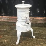 An early 20th century white painted cast iron patio heater,