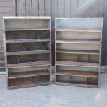 A pair of grey painted vintage metal workshop shelves,