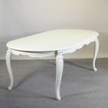 A cream painted oval dining table, 220 x 110cm,