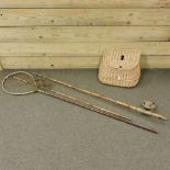 An early 20th century cane fishing rod, in three sections, with reel,