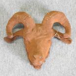 A large rusted metal ram's head,