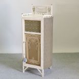 An early 20th century French cream painted hat cupboard,