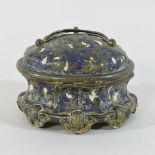 A 19th century continental champleve enamel dressing table jar, of oval shape with a hinged lid,