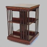 An Edwardian mahogany and inlaid revolving bookcase, with slatted divisions,