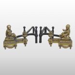 A pair of continental brass and iron figural andirons, in the form of a girl and boy,