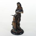 A bronze figure of a lady holding doves,