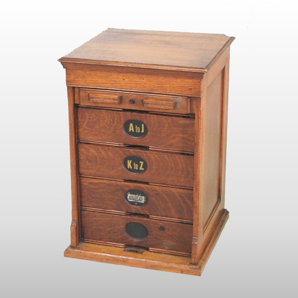 An early 20th century light oak filing cabinet,