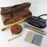 + An early 20th century leather Gladstone bag, by Harrods, containing various scales and tools,