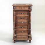 A 19th century French carved walnut narrow chest, with an inset marble top, containing six drawers,