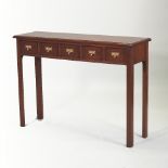 A bespoke mahogany narrow table, containing five short labelled spice drawers, on square legs,