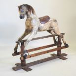 An early 20th century carved wooden 'Sportboy' rocking horse, by Lines, on a wooden rocker,