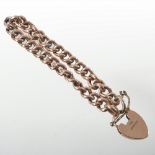 An early 20th century curb link bracelet, with a 9 carat gold padlock shaped clasp,