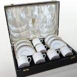A Spode bone china Queens Gate pattern coffee set, with six place settings, in a fitted case,